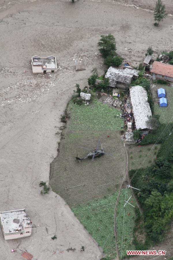 A helicopter arrives at a settlement site in Caopo Township of Wenchuan County, southwest China's Sichuan Province, July 16, 2013. The People's Liberation Army (PLA) Chengdu Military Area Command has dispatched helicopters to help with relief work in Wenchuan County which has been affected by flooding. An aviation unit dispatched three helicopters with 19 relief workers and 7.5 tonnes of materials in 12 flights to Caopo Township of Wenchuan County, which suffered downpours and mud-rock flows, according to the area command. (Xinhua/Wu Tailiang)