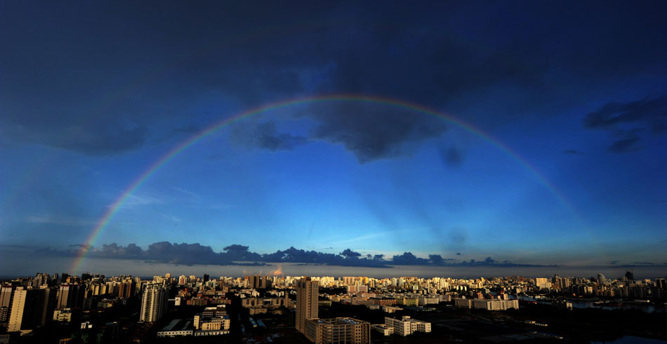 A rare double rainbow appears after a fierce downpour in south China’s Haikou city, July 9, 2013. (Xinhua/Zhao Yingquan)