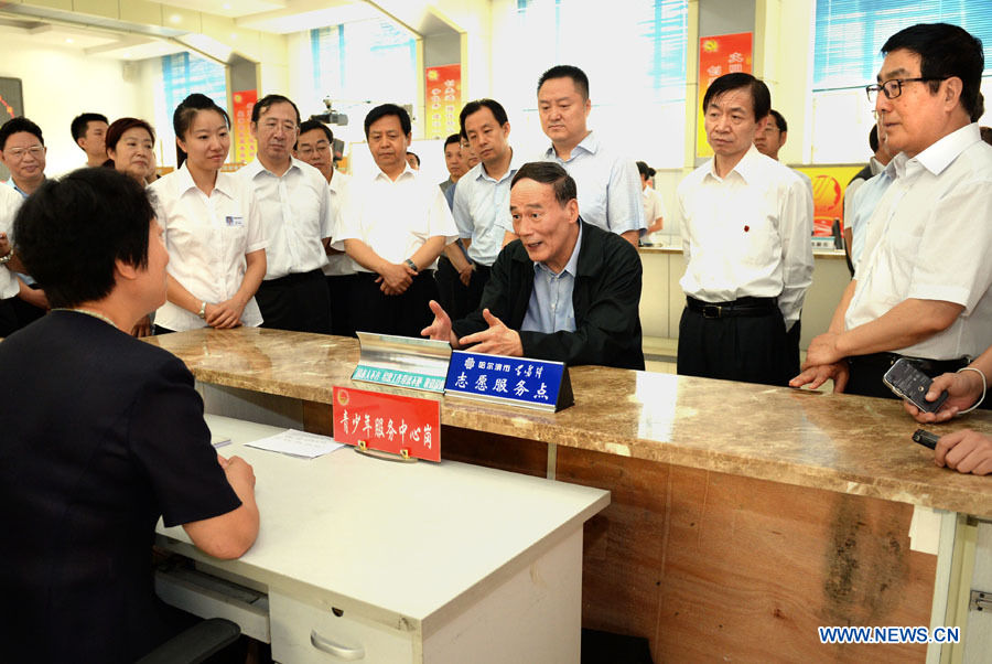 Wang Qishan, a member of the Standing Committee of the Political Bureau of the Communist Party of China (CPC) Central Committee, visits the Fushun Street Community in Harbin, capital of northeast China's Heilongjiang Province, July 9, 2013. China's top leadership has called on local officials to vigorously promote the "mass line" education campaign and apply it to boosting development and people's livelihoods. "Mass line" refers to a guideline under which CPC officials and members are required to prioritize the interests of the people and persist in representing them and working on their behalf. (Xinhua/Liu Jiansheng)