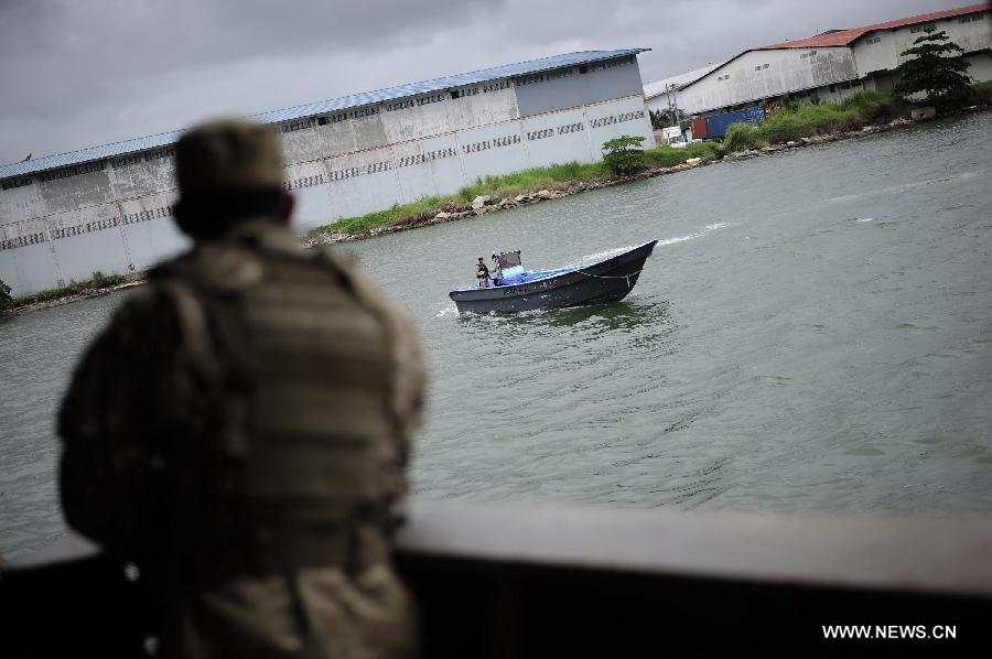 A Panamanian patrol boat guards near a cargo ship of the Democratic People's Republic of Korea (DPRK) at the Manzanillo Port in Colon City, Panama, on July 16, 2013. The Cuban Foreign Ministry said on Tuesday that a cargo ship of the Democratic People's Republic of Korea (DPRK) seized in Panama was loaded with anti-aircraft missile parts and MiG-21 fighter jets to be returned to the DPRK for repair. (Xinhua/Mauricio Valenzuela) 