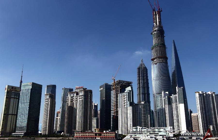 Photo taken on July 17, 2013 shows Shanghai Tower under construction in east China's Shanghai. Shanghai Tower is soon to seal its roof and will redefine the Lujiazui area skyline.(Xinhua/Pei Xin)