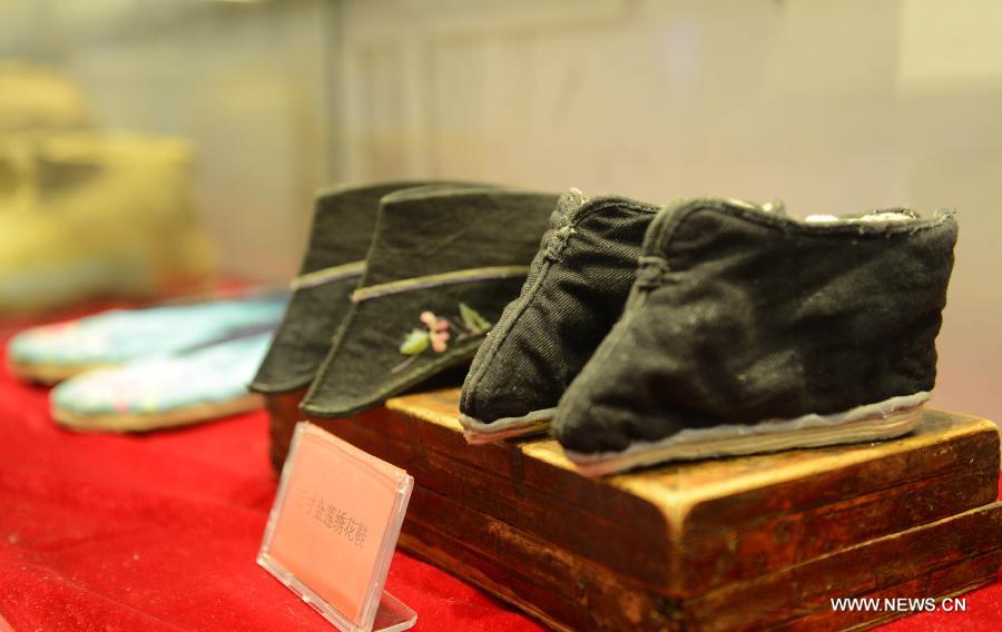 Photo taken on July 16, 2013 shows pairs of three-inch "golden lotuses" shoes in a museum of old objects in Yanzhangzi Village of the Man Autonomous County of Kuancheng, north China's Hebei Province. A museum collecting old stuff was set up in the village to remind the local residents of hard time in the old days. (Xinhua/Wang Min) 