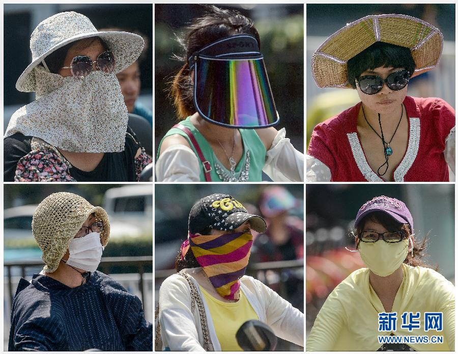 People wear sunhat and mask to block the sunshine on July. 11, 2013, Hangzhou, east China's Zhejiang province. The temperature of most parts in Zhejiang province reached 37 to 40 degrees Celsius. (Xinhua/Han Chuanhao)