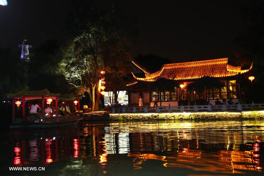 Photo taken on July 17, 2013 shows the night view of the Slender West Lake in Yangzhou, east China's Jiangsu Province. The night tour for visiting the Slender West Lake opened here on Wednesday. (Xinhua/Dong Hui)