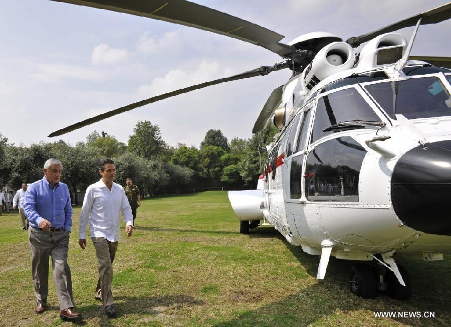 Image provided by Mexico's Presidency of Mexican President Enrique Pena Nieto (R) and his counterpart of Guatemala Otto Perez Molina walking towards a helicopter that will take them to the state of Guerrero, in Mexico City, capital of Mexico, on July 17, 2013. Otto Perez Molina visits Mexico to discuss issues of security and energy as well as the fight against hunger, according to the local press. (Xinhua/Mexico's Presidency) 