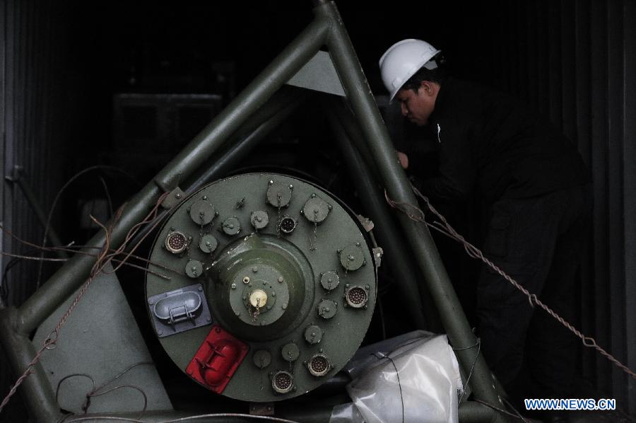 An investigation officer inspects a container with military equipments aboard the "Chong Chon Gang" vessel from the Democratic People's Republic of Korea (DPRK), at the Manzanillo International container terminal on the coast of Colon City, Panama, July 17, 2013. The Democratic People's Republic of Korea (DPRK) on Thursday demanded the release of a vessel seized in Panama suspected of carrying narcotic drugs and banned arms, claiming the weapons were being transported under a legitimate contract with Cuba, the official KCNA news agency reported. (Xinhua/Mauricio Valenzuela)