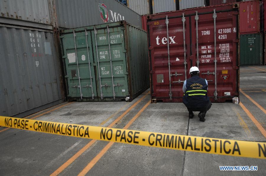 An investigation officer inspects a container with military equipments aboard the "Chong Chon Gang" vessel from the Democratic People's Republic of Korea (DPRK), at the Manzanillo International container terminal on the coast of Colon City, Panama, July 17, 2013. The Democratic People's Republic of Korea (DPRK) on Thursday demanded the release of a vessel seized in Panama suspected of carrying narcotic drugs and banned arms, claiming the weapons were being transported under a legitimate contract with Cuba, the official KCNA news agency reported. (Xinhua/Mauricio Valenzuela)