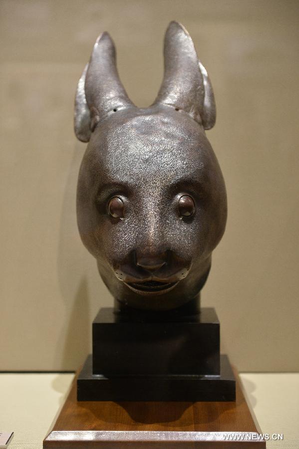 A bronze head of a rabbit is on display at the National Museum of China in Beijing, capital of China, July 18, 2013. The bronze heads of a rat and a rabbit, donated by the Pinault family of France in April, were on display at the museum Thursday. The two pieces of relics were among 12 animal head sculptures that formed a zodiac water clock previously stood at Yuanmingyuan, or the Old Summer Palace, in northwest Beijing. They were looted by Anglo-French Allied forces during the Second Opium War in 1860. (Xinhua/Li Xin)