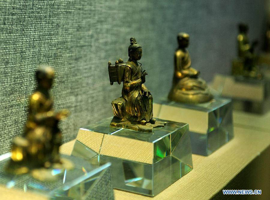 Buddhists figurines are on display at the Bingling Temple Grottoes in Yongjing County, northwest China's Gansu Province, July 17, 2013. Listed as part of the ancient Silk Road for the World Heritage candidate, the grottoes will be reviewed by experts from U.N. Educational, Scientific and Cultural Organization after renovation of a giant Buddha statue dating back more than 1,000 years to the Tang Dynasty was completed lately. Bingling Temple Grottoes, filled with Buddhist statues, stupas and murals, were a work in progress between the 4th and 10th centuries. (Xinhua/Nie Jianjiang)