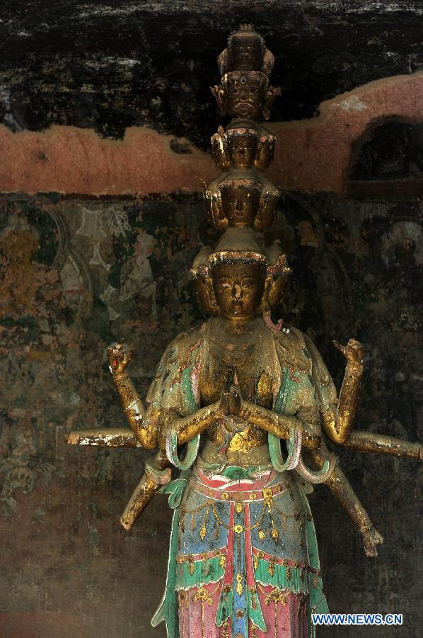 A Buddhist statue is seen at the Bingling Temple Grottoes in Yongjing County, northwest China's Gansu Province, July 17, 2013. Listed as part of the ancient Silk Road for the World Heritage candidate, the grottoes will be reviewed by experts from U.N. Educational, Scientific and Cultural Organization after renovation of a giant Buddha statue dating back more than 1,000 years to the Tang Dynasty was completed lately. Bingling Temple Grottoes, filled with Buddhist statues, stupas and murals, were a work in progress between the 4th and 10th centuries. (Xinhua/Nie Jianjiang)