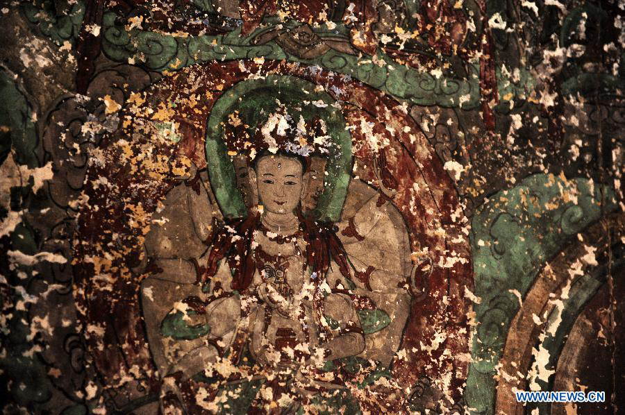 A piece of mural is seen at the Bingling Temple Grottoes in Yongjing County, northwest China's Gansu Province, July 17, 2013. Listed as part of the ancient Silk Road for the World Heritage candidate, the grottoes will be reviewed by experts from U.N. Educational, Scientific and Cultural Organization after renovation of a giant Buddha statue dating back more than 1,000 years to the Tang Dynasty was completed lately. Bingling Temple Grottoes, filled with Buddhist statues, stupas and murals, were a work in progress between the 4th and 10th centuries. (Xinhua/Nie Jianjiang)