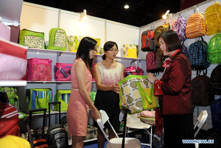 People visit the 3rd China-Asean Commodity Fair in Bangkok, Thailand, on July 18, 2013. The 3rd China-Asean Commodity Fair kicked off here on Thursday, attracting about 250 Chinese companies. (Xinhua/Gao Jianjun)