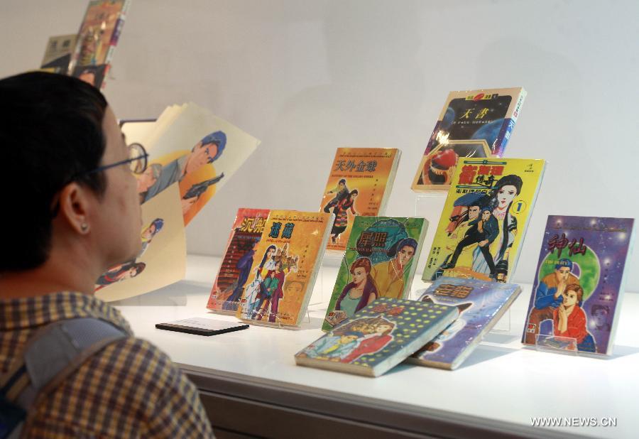 People visit an exhibition marking the 50th annivesary of the birth of Wesley, the main character in a series of science fictions written by novelist Ni Kuang, during the 24th Hong Kong Book Fair in south China's Hong Kong, July 18, 2013. The seven-day book fair, which kicked off Wednesday at Hong Kong Convention and Exhibition Center, attracted 560 exhibitors from 30 countries and regions. (Xinhua/Jin Yi)