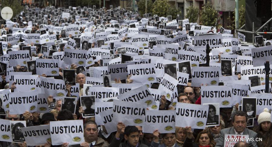 Residents participate in a rally to commemorate the 19th anniversay of the terrorist attack to the Argentine Israelite Mutual Association (AMIA, for its acronym in Spanish), in Buenos Aires, capital of Argentina, on July 18, 2013. The commemoration began at 9:53 a.m., the exact same time at which the explosion at the entrance of the AMIA building occured on July 18, 1994, leaving 85 people dead and more than 300 injured. (Xinhua/Martin Zabala) 