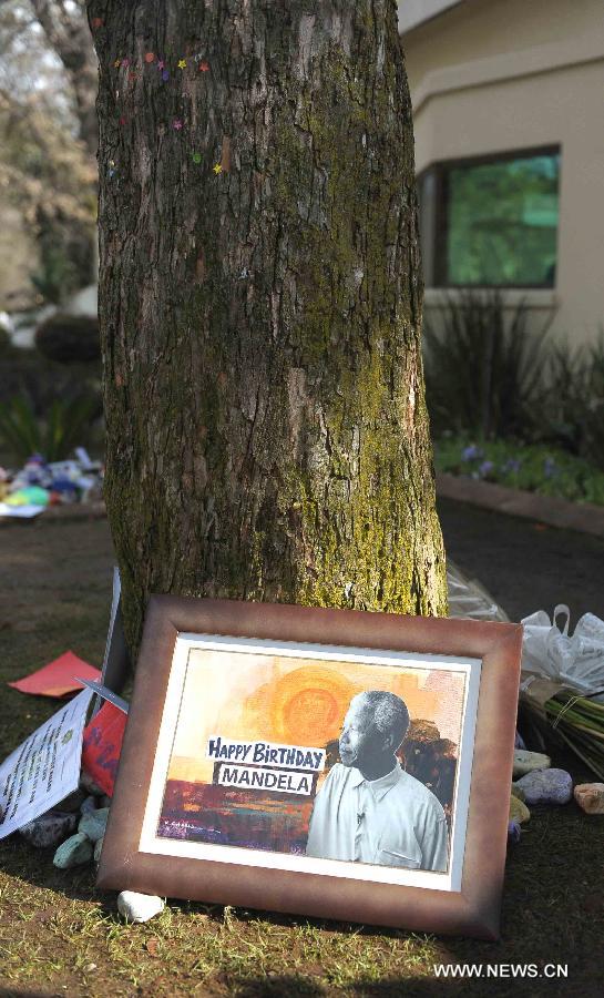 A picture with wishes is seen outside Mandela's house in Johannesburg, South Africa, on July 18, 2013. South African former president Mandela is steadily improving, according to the Presidency website update released on Thursday. "Madiba remains in hospital in Pretoria but his doctors have confirmed that his health is steadily improving," said the statement. President Jacob Zuma wished the founding father of the nation a happy 95th birthday. (Xinhua/Li Qihua)