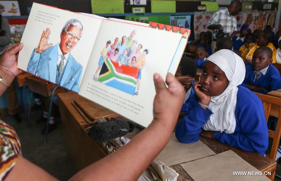 Students listen to stories on Mandela's long walk to freedom at Kilimani Primary School in Nairobi, capital of Kenya, July 18, 2013. A variety of activities, including tree planting, library wall painting and storytelling on Mandela's long walk to freedom, were held here on Thursday to celebrate Nelson Mandela Day. The theme for this year is "Take Action, Inspire Change and Make Every Day a Mandela Day." (Xinhua/Meng Chenguang) 