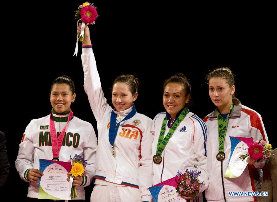 (From L to R) Silver medalist Mexico's Briseida Acosta, gold medalist Olga Ivanova of Russia and bronze medal winners Anne-Caroline Graffe of France and Ana Bajic of Serbia pose during the awarding ceremony of the final of the 73 kg women's category of the Taekwondo World Championship of the World Taekwondo Federation (WTF), at the Expositions and Coventions Center of Puebla, in Puebla, Mexico, on July 18, 2013. (Xinhua/Guillermo Arias)
