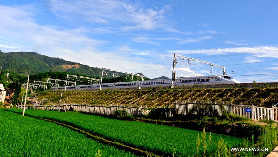 A test bullet train moves on Xiangtang-Putian Railway, or Xiangpu Railway, during a joint debugging and commissioning process, July 17, 2013. The 632-kilometer-long railway, which links Xiangtang Township in Nanchang, capital of east China's Jiangxi Province, and Putian City in southeast China's Fujian Province, is expected to open to traffic by the end of this September after all debugging and commissioning finishes. The Xiangpu Railway, which will be one of the key transportation arteries for both travellers and goods in this area after it is opened to traffic, will also be the first railway running through seven districts and counties in Jiangxi and Fujian. (Xinhua/Chen Chunyuan)