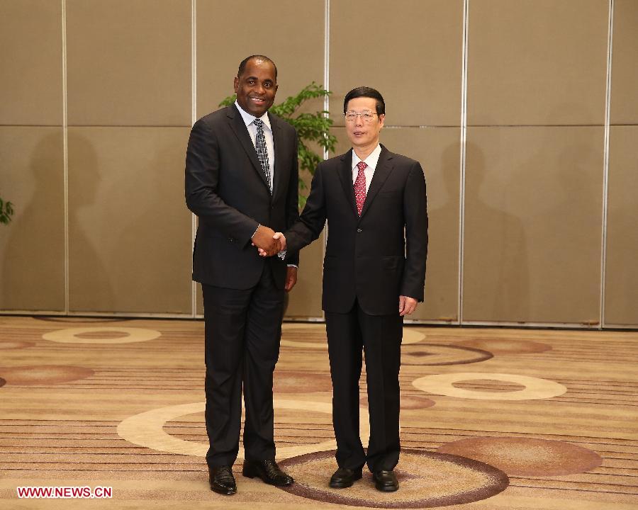 Chinese Vice Premier Zhang Gaoli (R) shakes hands with Dominican Prime Minister Roosevelt Skerrit in Guiyang, capital of southwest China's Guizhou Province, July 19, 2013. Zhang Gaoli on Friday met with four foreign leaders who will attend the opening ceremony of the Eco-Forum Global in Guiyang. (Xinhua/Wang Ye)