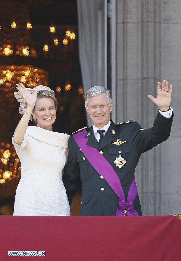 Belgium's newly sworn in King Philippe and Queen Mathilde wave to people on the balcony of Royal Palace in Brussels, capital of Belgium, on July 21, 2013, the country's national day. Prince Philippe was sworn in before parliament as Belgium's seventh king on Sunday, after his father Albert II abdicated. (Xinhua/Ye Pingfan)