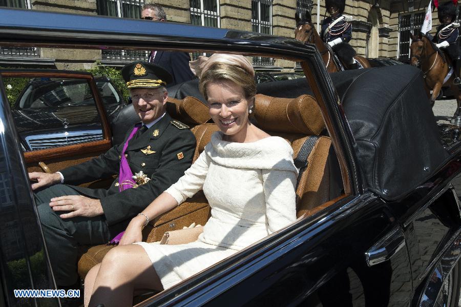King Philippe of Belgium and his wife Princess Mathilde prepare to leave after taking the oath in Brussels, on July 21, 2013. Prince Philippe was sworn in before parliament as Belgium's seventh king on Sunday, the country's national day, after his 79-year-old father Albert II abdicated. (Xinhua/POOL)