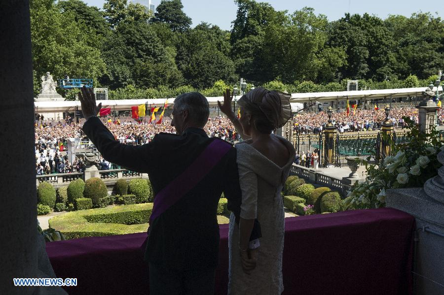 King Philippe of Belgium and his wife Princess Mathilde salute to people from the balcony of Royal Palace in Brussels, on July 21, 2013. Prince Philippe was sworn in before parliament as Belgium's seventh king on Sunday, the country's national day, after his 79-year-old father Albert II abdicated. (Xinhua/POOL)