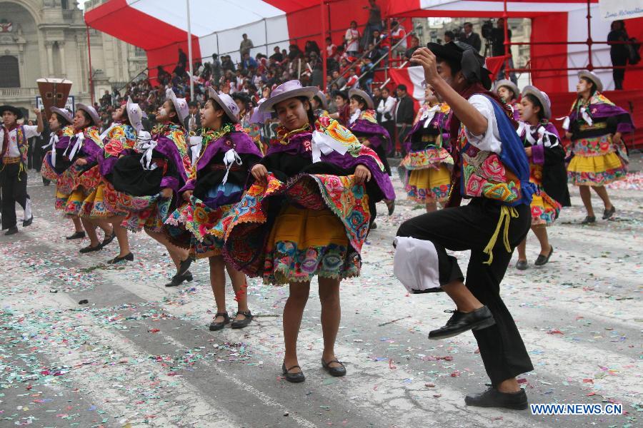 Youth participate in a school parade performing folk dances of Peru, in the Armas Square of the city of Peru, capital of Peru, on July 20, 2013. The "Third School Parade", which is called Millennial and Cultural Lima and organized by the city of Lima, brings together all the schools in the city to commemorate the upcoming national holiday on July 28. (Xinhua/Luis Camacho) 