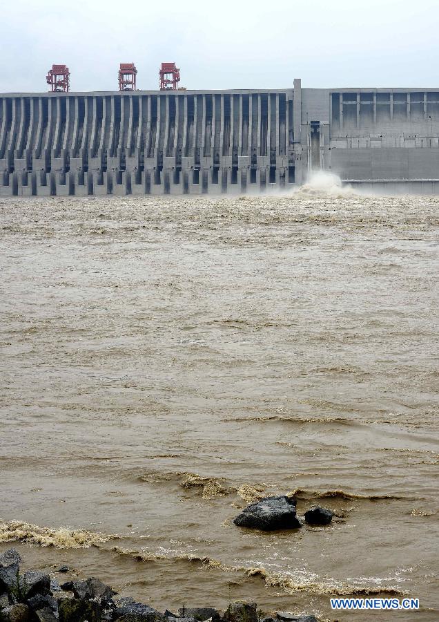 Photo taken on July 21, 2013 shows the Three Gorges Dam, a gigantic hydropower project on the Yangtze River, central China's Hubei Province. The Yangtze River, China's longest, braced for its largest flood peak so far this year due to continuous rainfall upstream. Water flow into the reservoir of the Three Gorges Dam reached 49,000 cubic meters per second on Sunday morning. (Xinhua/Lei Yong)