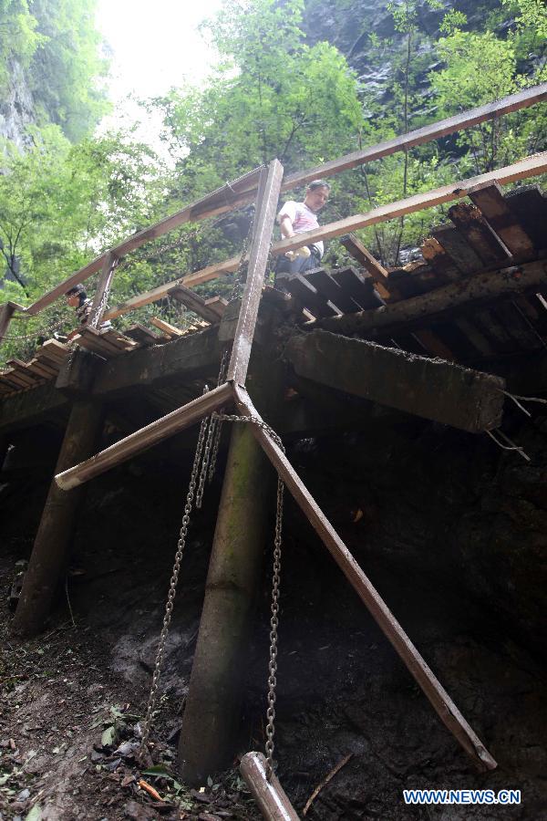 Photo taken on July 21, 2013 shows a collapsed rim skywalk after a landslide in the Jinsixia Gorge, northwest China's Shaanxi Province. One tourist was killed and 18 others injured by falling rocks at Jinsixia Gorge on Sunday morning. The gorge has been closed temporarily. (Xinhua)