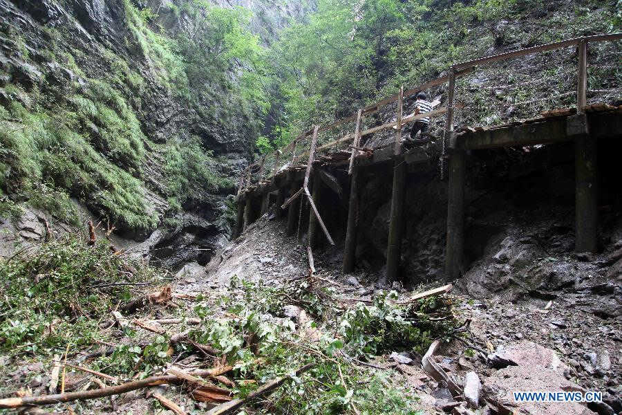 Photo taken on July 21, 2013 shows a collapsed rim skywalk after a landslide in the Jinsixia Gorge, northwest China's Shaanxi Province. One tourist was killed and 18 others injured by falling rocks at Jinsixia Gorge on Sunday morning. The gorge has been closed temporarily. (Xinhua)