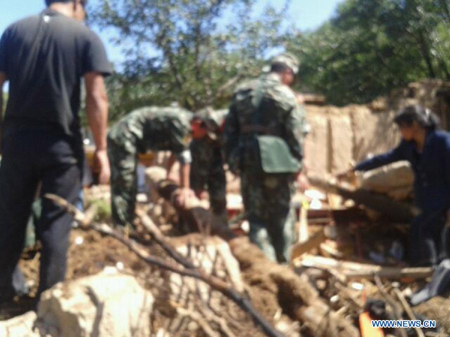 Photo taken with a mobile phone shows rescuers work in quake-hit Meichuan Town of Minxian County, northwest China's Gansu Province, July 22, 2013. A 6.6-magnitude earthquake jolted a juncture region of Minxian County and Zhangxian County in Dingxi City Monday morning. (Xinhua)