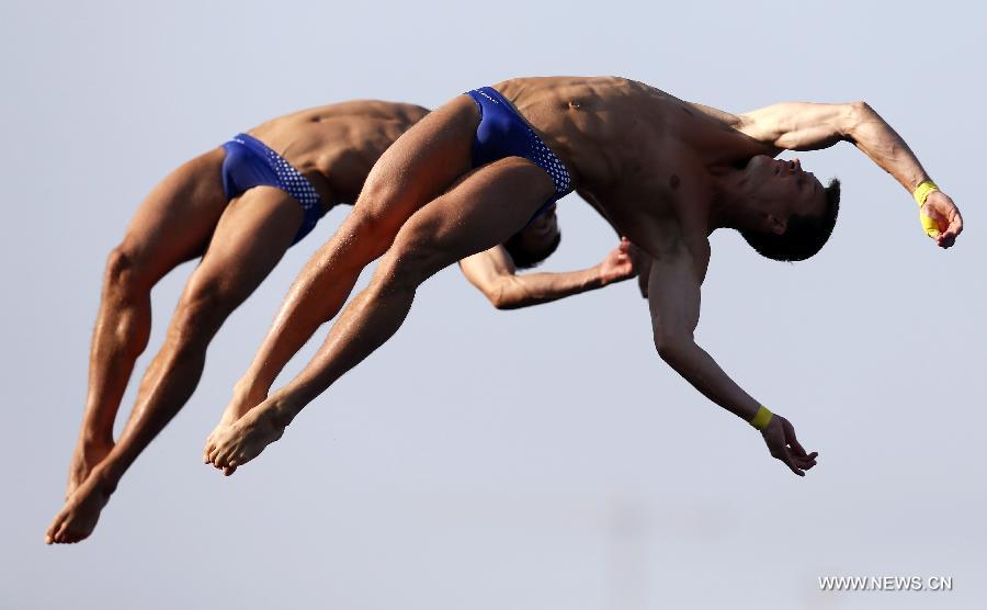 Germany's Sascha Klein (L) and Patrick Hausding compete during the men's 10m synchro platform final of the Diving competition in the 15th FINA World Championships at the Piscina Municipal de Montjuic in Barcelona, Spain, on July 21, 2013. Sascha Klein and Patrick Hausding claimed the title with a total socre of 461.46 points. (Xinhua/Wang Lili)