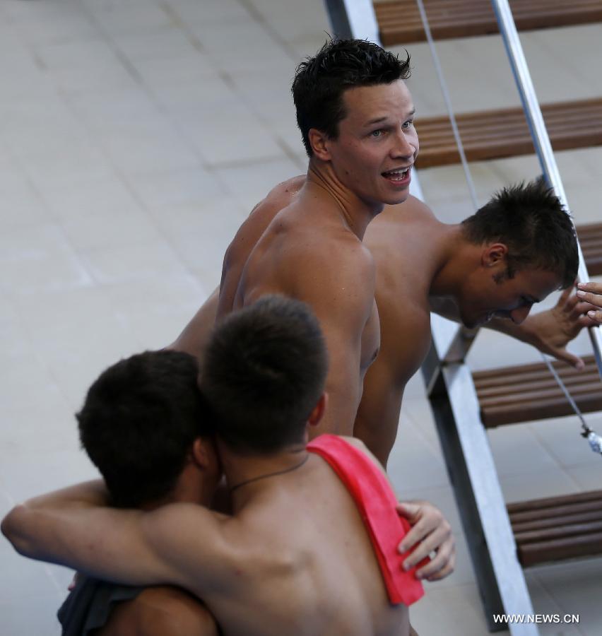 Germany's Sascha Klein and Patrick Hausding (2nd R) celebrate after the men's 10m synchro platform final of the Diving competition in the 15th FINA World Championships at the Piscina Municipal de Montjuic in Barcelona, Spain, on July 21, 2013. Sascha Klein and Patrick Hausding claimed the title with a total socre of 461.46 points. (Xinhua/Wang Lili)