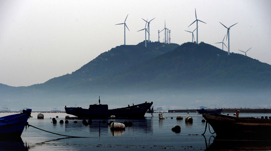 Photo taken on May 25, 2013 shows the wind power generation equipment on Beichangshan Island in Changdao county, east China's Shandong province. According to a report released by State Grid Corporation on July 13, 2013, 26.6 percent of the installed equipment in the region where it operates is clean energy equipment, which marks the energy structure has been optimized China. (Xinhua/Guo Xulei) 