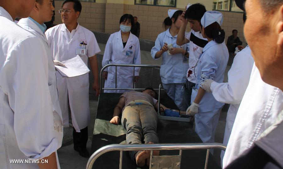 A victim of an earthquake receives treatment at a hospital in Minxian County, northwest China's Gansu Province, July 22, 2013. At least 56 people were killed and 14 others are missing as of 3 p.m. on Monday following the 6.6-magnitude earthquake striking at 7:45 a.m. on Monday at the border of Minxian County and Zhangxian County in the city of Dingxi. Another 392 people were injured in the quake, which also cut off communications in 13 townships in Zhangxian, according to the provincial earthquake emergency response center. (Xinhua/Han Congzhi)