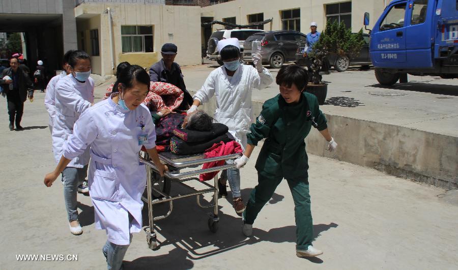 Medical workers transfer a victim at a hospital in Minxian County, northwest China's Gansu Province, July 22, 2013. At least 56 people were killed and 14 others are missing as of 3 p.m. on Monday following the 6.6-magnitude earthquake striking at 7:45 a.m. on Monday at the border of Minxian County and Zhangxian County in the city of Dingxi. Another 392 people were injured in the quake, which also cut off communications in 13 townships in Zhangxian, according to the provincial earthquake emergency response center. (Xinhua/Han Congzhi)