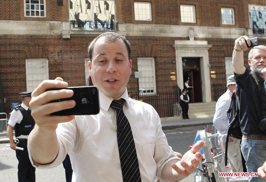 Reporters gather outside the Lindo Wing of St. Mary's Hospital in London, July 22, 2013. The nation awaits news of a new royal baby. The nation awaits news of a new royal baby as Prince William's wife Kate has gone into labour and been admitted to St. Mary's Hospital for the birth of the couple's first child. (Xinhua/Yin Gang)