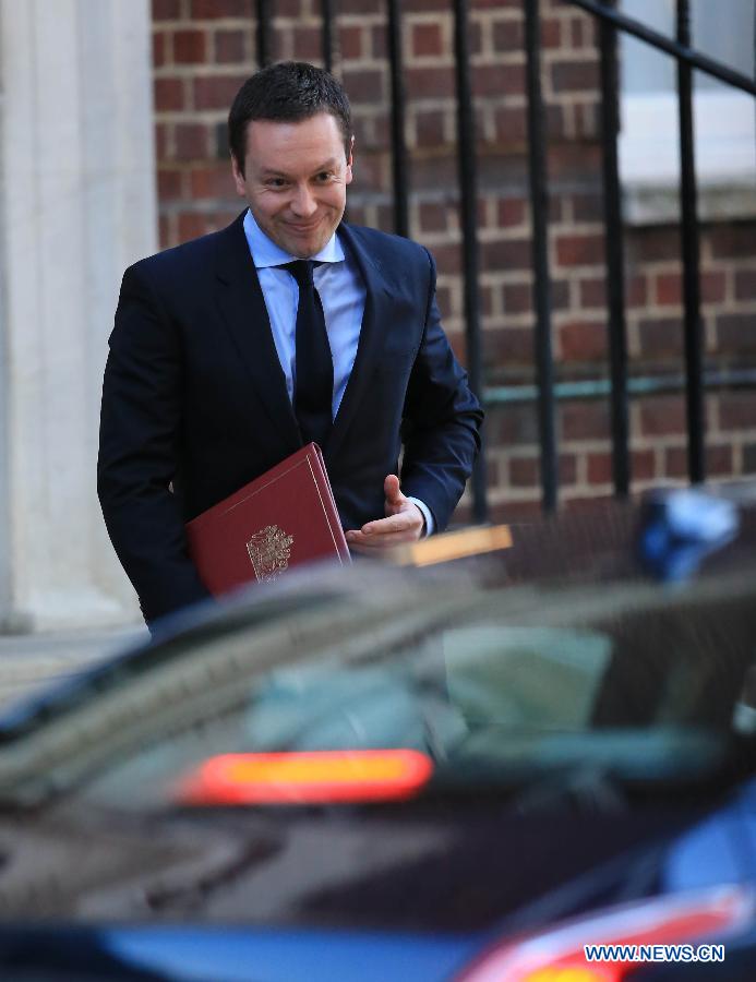 Royal Household Press secretary Ed Perkins carries a official announcement to a waiting car on route to the Buckingham Palace to deliver the news of the birth of Prince William and his wife Catherine's baby boy at the Lindo Wing of St Mary's Hospital in London, on July 22, 2013. Britain's Duchess of Cambridge Kate gave birth to a boy on Monday afternoon. (Xinhua/Yin Gang)