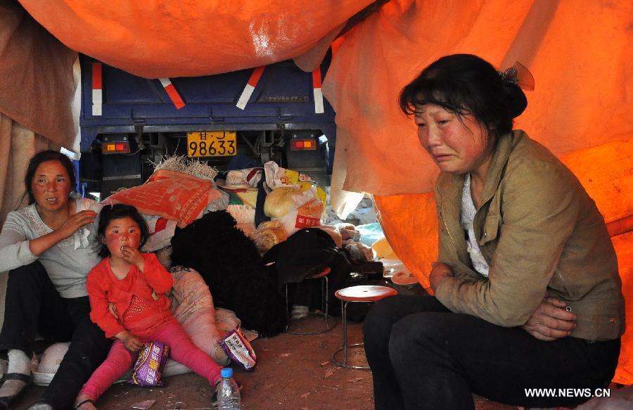 Villagers rest in a tent at quake-hit Majiagou Village of Minxian County, northwest China's Gansu Province, July 22, 2013. The death toll has climbed to 89 in the 6.6-magnitude earthquake which jolted a juncture region of Minxian County and Zhangxian County in Dingxi City Monday morning. (Xinhua/Guo Gang) 