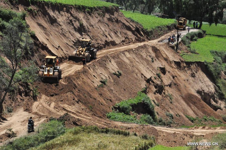 Rescuers repair the road at quake-hit Majiagou Village of Minxian County, northwest China's Gansu Province, July 22, 2013. The death toll has climbed to 89 in the 6.6-magnitude earthquake which jolted a juncture region of Minxian County and Zhangxian County in Dingxi City Monday morning. (Xinhua/Huang Wenxin) 