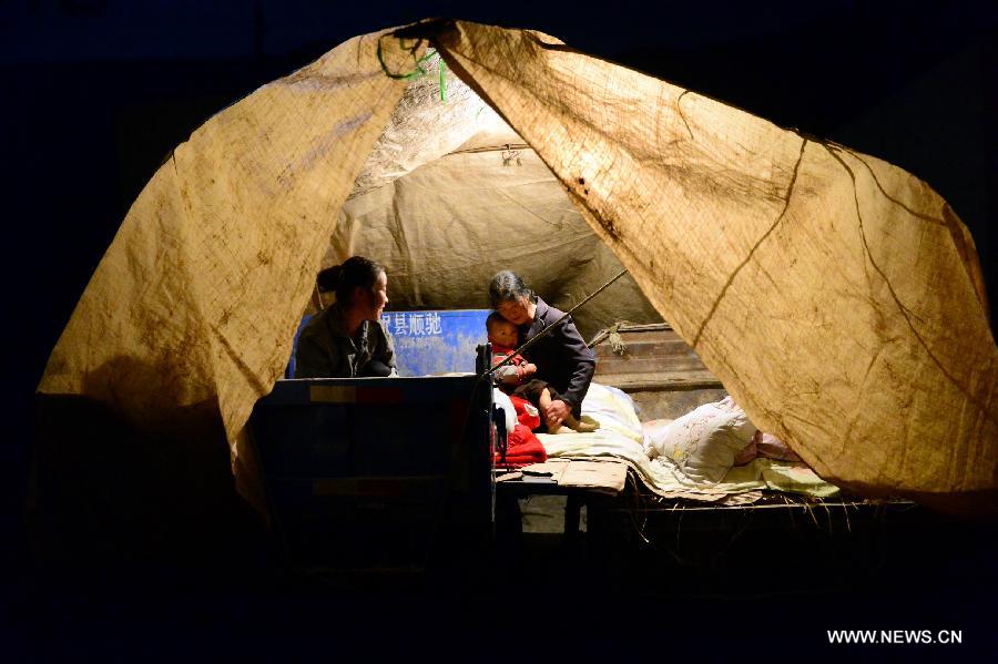 Villagers rest in a tent at quake-hit Hetuo Village of Minxian County, northwest China's Gansu Province, July 22, 2013. The death toll has climbed to 89 in the 6.6-magnitude earthquake which jolted a juncture region of Minxian County and Zhangxian County in Dingxi City Monday morning. (Xinhua/Zhang Meng)