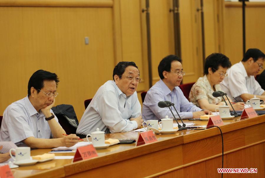 Yu Zhengsheng (2nd L), chairman of the National Committee of the Chinese People's Political Consultative Conference (CPPCC), speaks at the opening of the symposium for members of united front circles to study and implement the spirit of the 18th National Congress of the Communist Party of China (CPC), in Beijing, capital of China, July 22, 2013. (Xinhua/Liu Weibing)