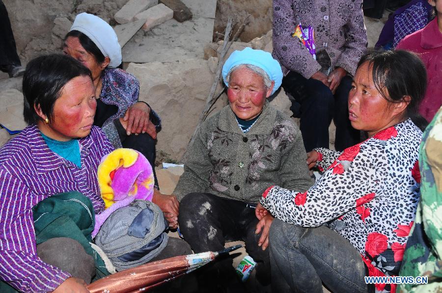 Victims wait for help after a 6.6-magnitude quake in Yongguang Village, Meichuan Town, Minxian County, northwest China's Gansu Province, July 22, 2013. At least nine villagers in Yongguang were killed in the quake and 12 others were burried in a landslide triggered by the quake. The rescue work is underway. (Xinhua/Tu Guoxi) 