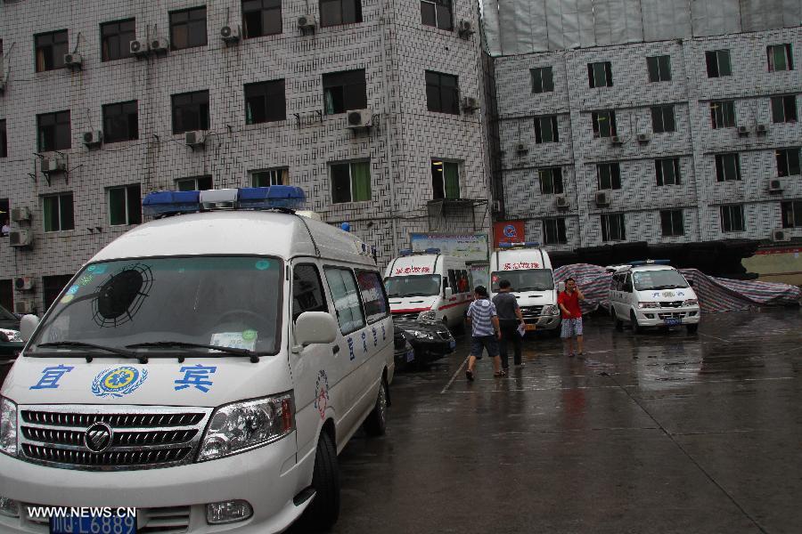 Ambulances wait outside the accident site at the Shanmushu Coal Mine, which is owned by the Sichuan Coal Group Furong Company, in Gongxian County of Yibin City, southwest China's Sichuan Province, July 23, 2013. Seven people remained trapped while 266 others have successfully escaped after the coal mine accident early on Tuesday morning. The seven trapped miners are all members of a team that was draining gas from the shaft. (Xinhua/Yi Youbo)