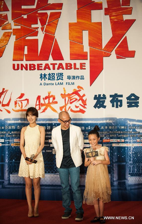 Director Dante Lam (M), actress Crystal Lee (R) and Li Feier attend the press conference of the movie "Unbeatable" in Beijing, capital of China, July 23, 2013. The movie "Unbeatable" which won both the Golden Goblet for best actor and actress in the 16th Shanghai International Film Festival will hit the screen on Aug. 16. (Xinhua/Li Yan)