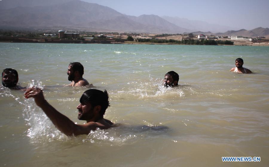 Afghan men cool themselves at a canal in Kabul, Afghanistan, on July 23, 2013. (Xinhua/Ahmad Massoud)