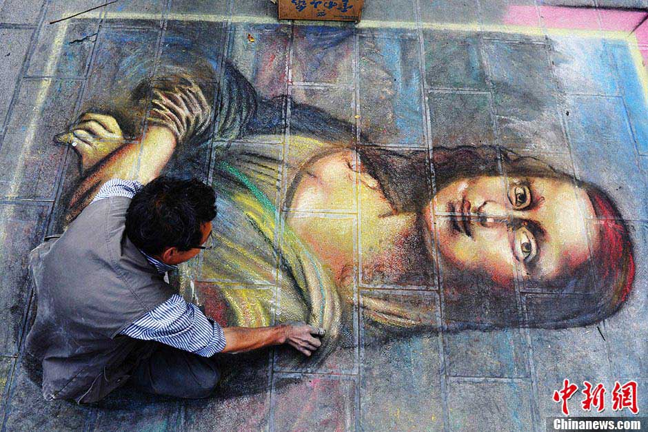 A painter who lost one leg uses chalk and carbon stick to draw “Mona Lisa” and “Avatar” on the street of Kunming, Yunnan province. Cong Guilan's left leg was amputated due to bone tumor when he was 16. Since then with love for arts and determination, he has started to learn drawing; he wishes to enter an art college for professional arts study. (CNS / Liu Ranyang)