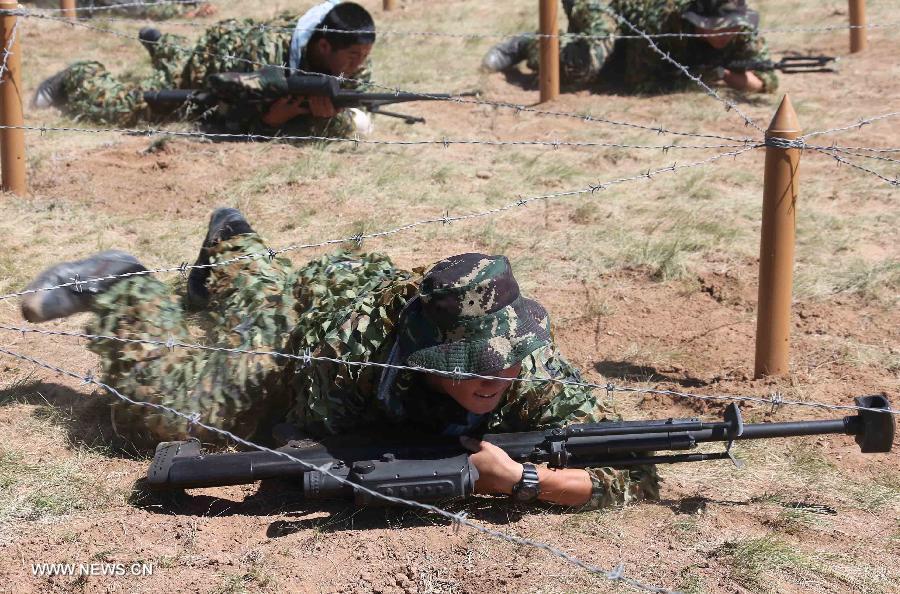 Members of China's People's Liberation Army (PLA) special forces participate in a comprehensive military contest at a PLA training base in north China's Inner Mongolia Autonomous Region, July 23, 2013. (Xinhua/Wang Jianmin)