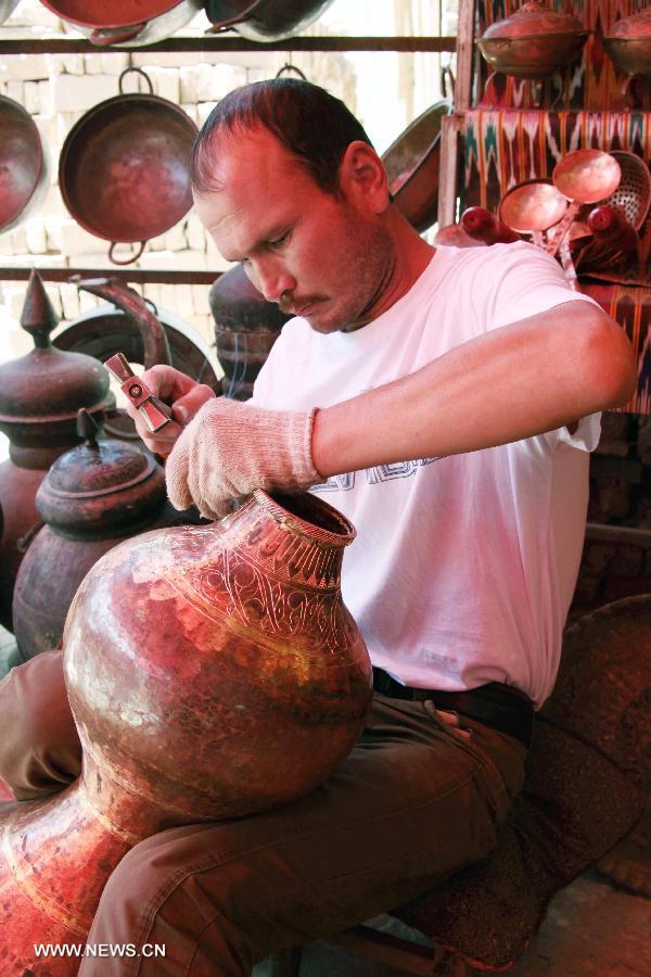 A craftman makes a handcraft work in Kashgar, northwest China's Xinjiang Uygur Autonomous Region, July 16, 2013.(Xinhua/Gao Wenfeng)