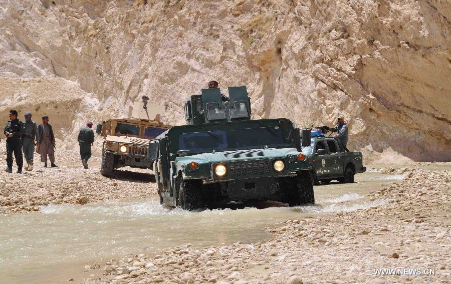 Afghan policemen patrol with their military vehicles during an operation against Taliban in Jawzjan province, northern Afghanistan, on July 24, 2013. (Xinhua/Arui)